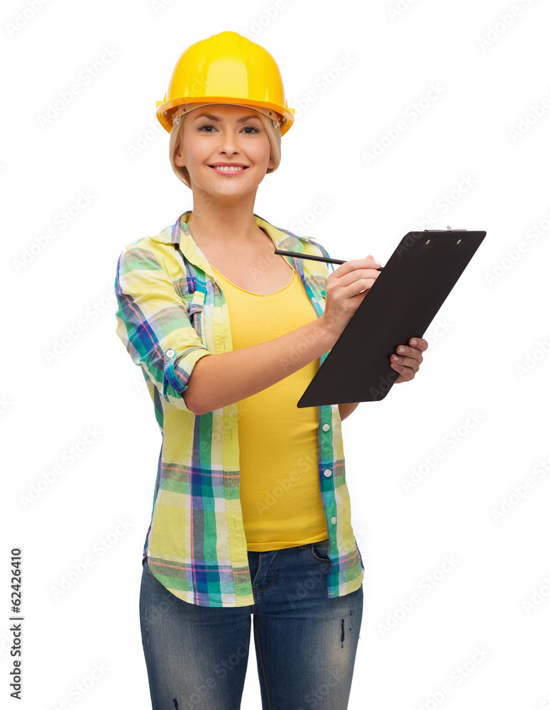 smiling woman in helmet with clipboard smiling woman in helmet with clipboard