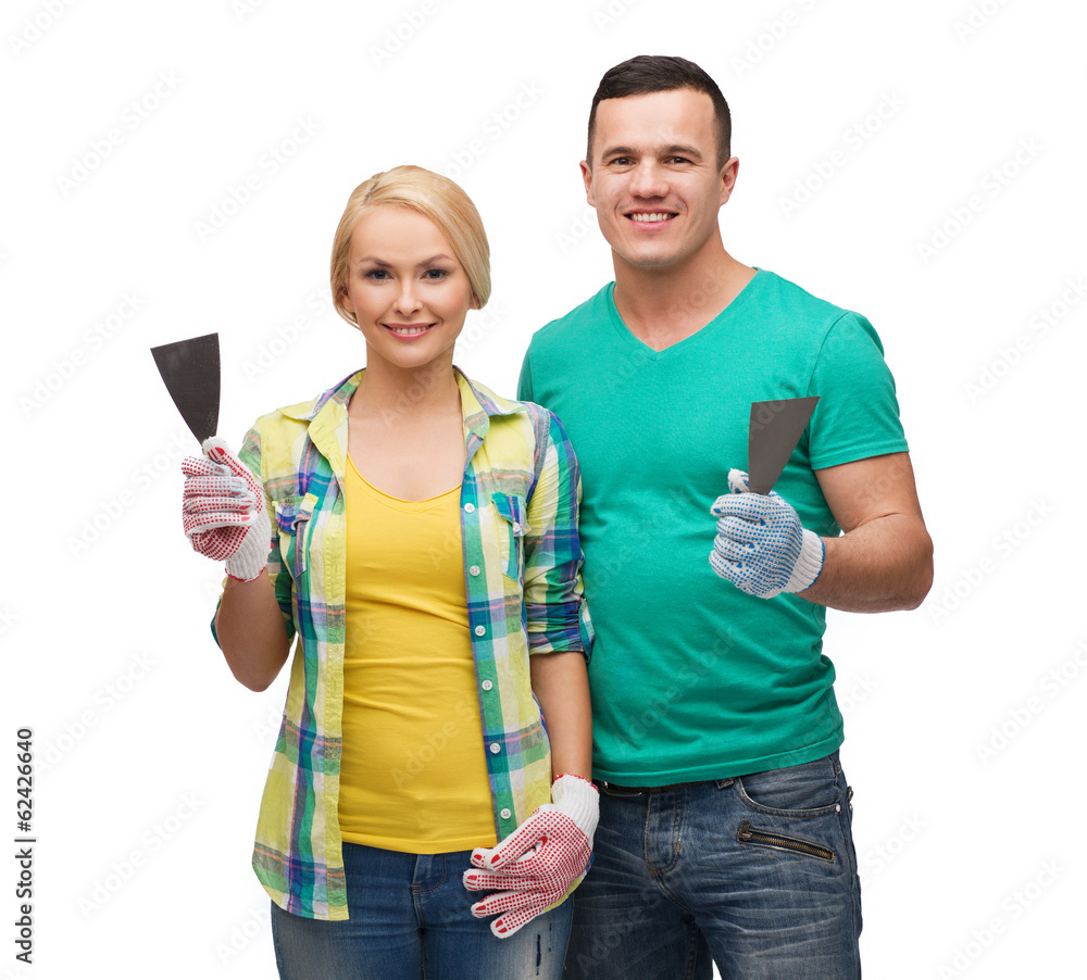smiling couple in gloves with spatula smiling couple in gloves with spatula
