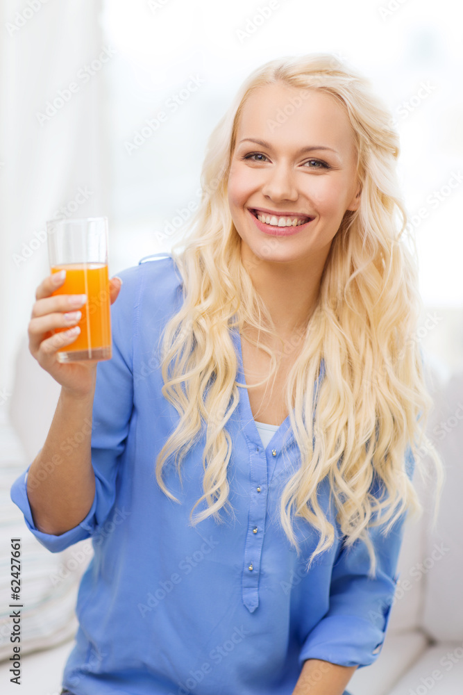 smiling woman with glass of orange juice at home smiling woman with glass of orange juice at home