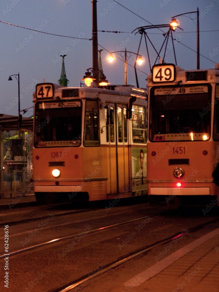Fototapeta premium two yellow trams at nightfall