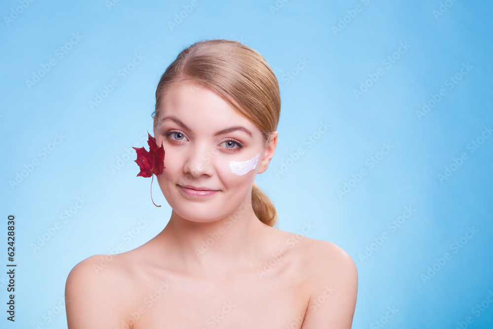 Skin care. Face of young woman girl with red maple leaf. Skin care. Face of young woman girl with red maple leaf.