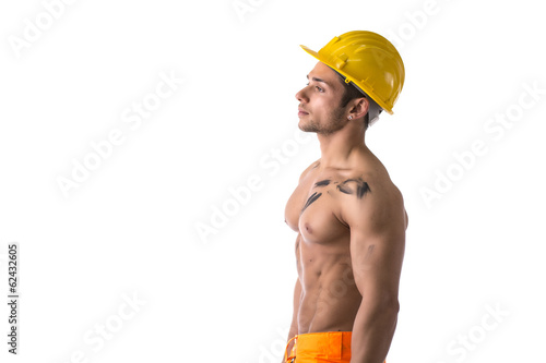 Profile view of muscular young construction worker shirtless