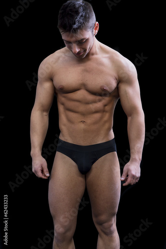 Photography Muscular young man semi naked looking down