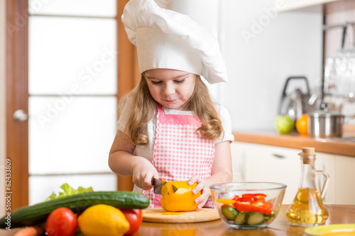 Kid girl weared as cook cut...