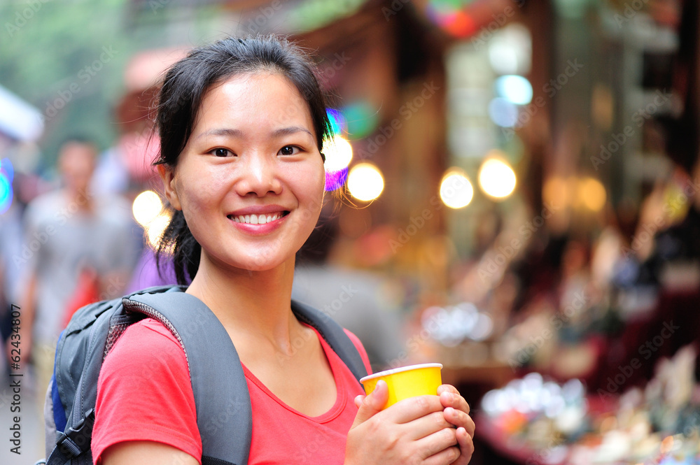 asian woman holding cup of coffee at xian street asian woman holding cup of coffee at xian street