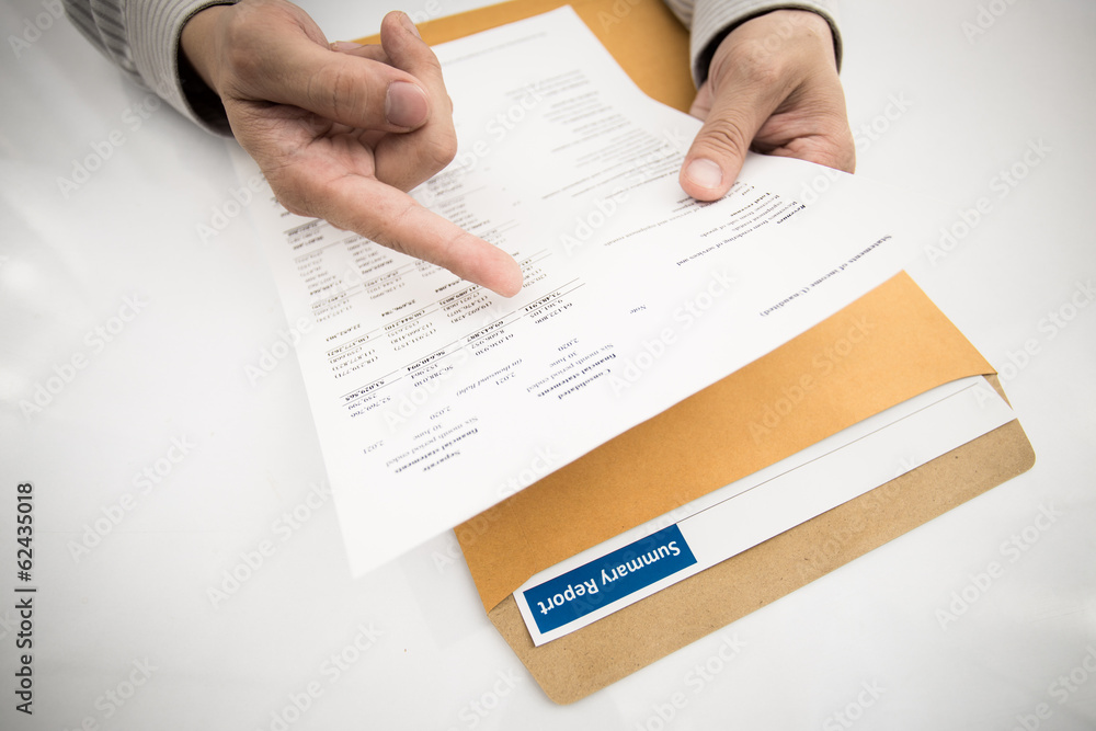 man hand with pen and business report man hand with pen and business report
