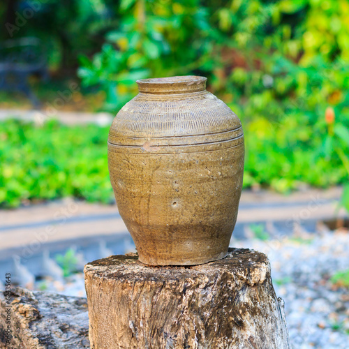Antique jar on the old log