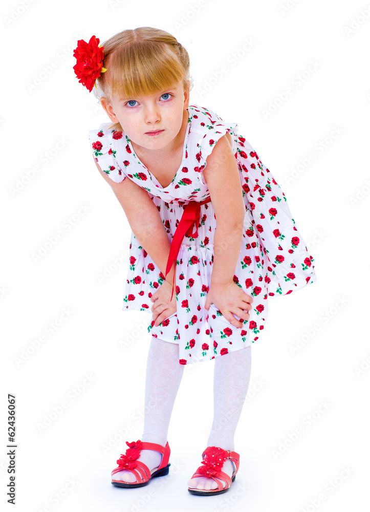 Cheerful little girl with red rose, braided hair, joking in the Cheerful little girl with red rose, braided hair, joking in the