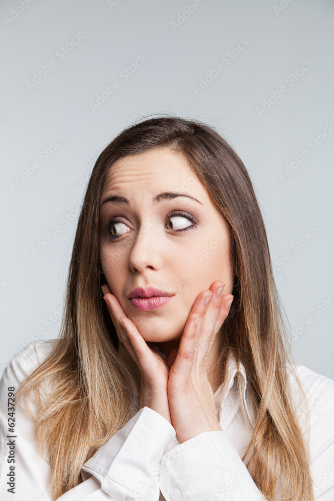 Close-up of a young woman looking surprised Close-up of a young woman looking surprised