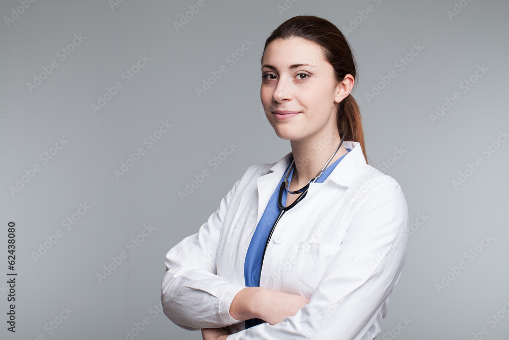 Close-up of a female doctor smiling with arms crossed Close-up of a female doctor smiling with arms crossed