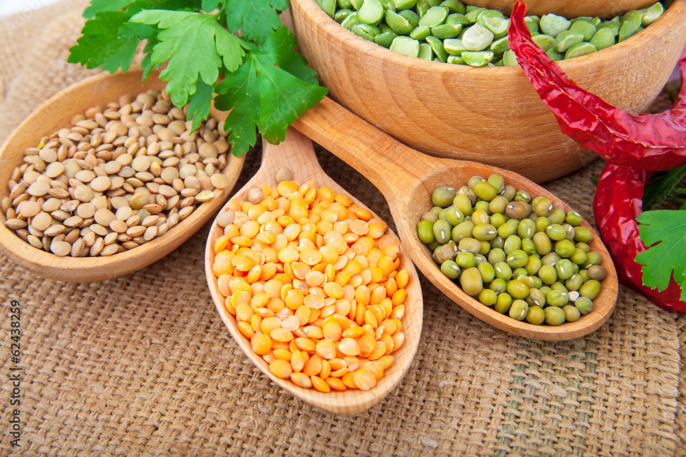 Lentil bean in wooden plate with spice, on burlap, food photo Lentil bean in wooden plate with spice, on burlap, food photo