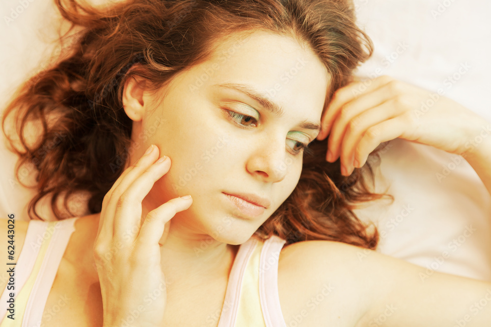 Naklejka premium portrait of a beautiful young woman with curly hair