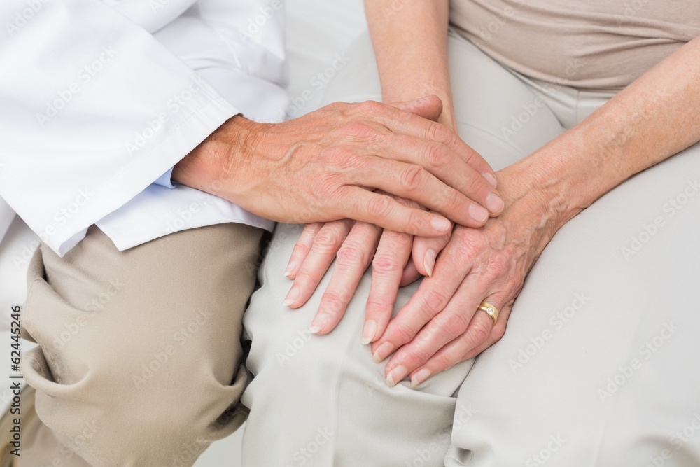 Mid section of a senior patient visiting doctor Mid section of a senior patient visiting doctor