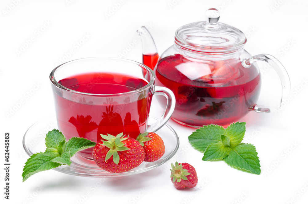 kettle and a cup of red tea with strawberries and mint isolated kettle and a cup of red tea with strawberries and mint isolated