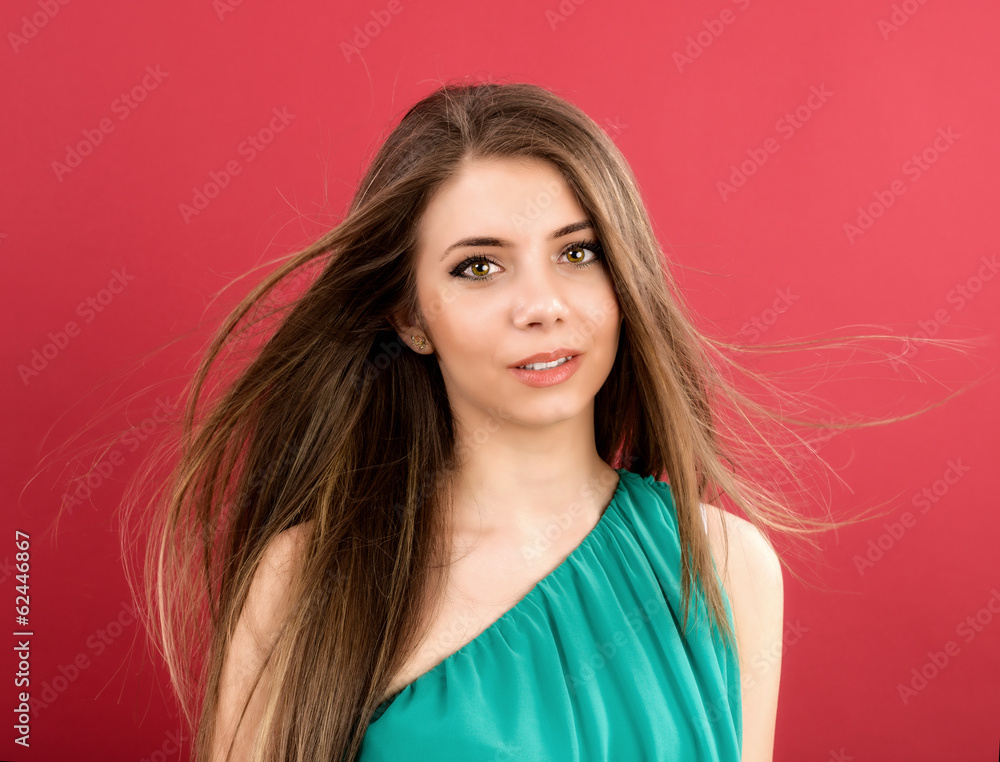 Fototapeta premium Portrait of beautiful woman on red background