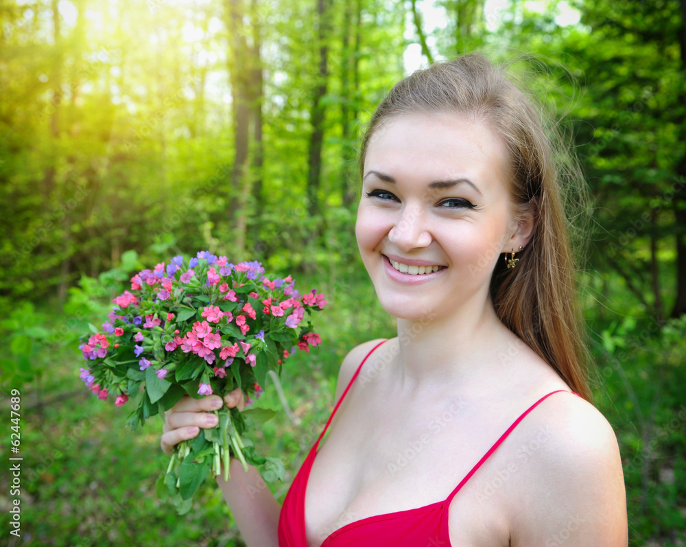 Beautiful young woman with the bouquet of spring flowers Beautiful young woman with the bouquet of spring flowers