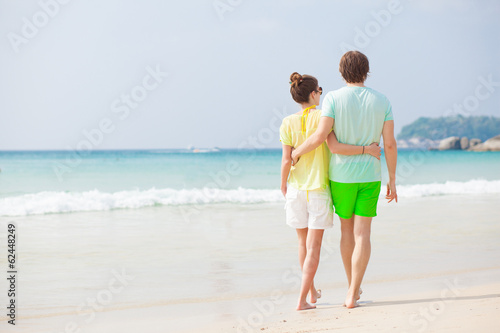 back view of couple hugging on tropical beach in Thailand