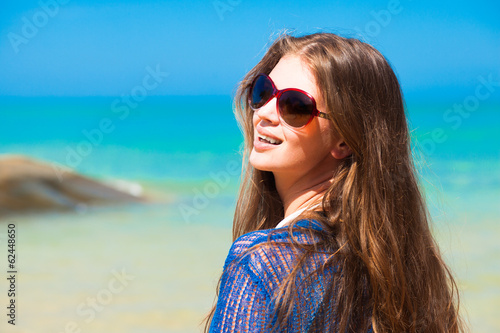 portrait of young pretty woman in sunglasses and blue shirt on