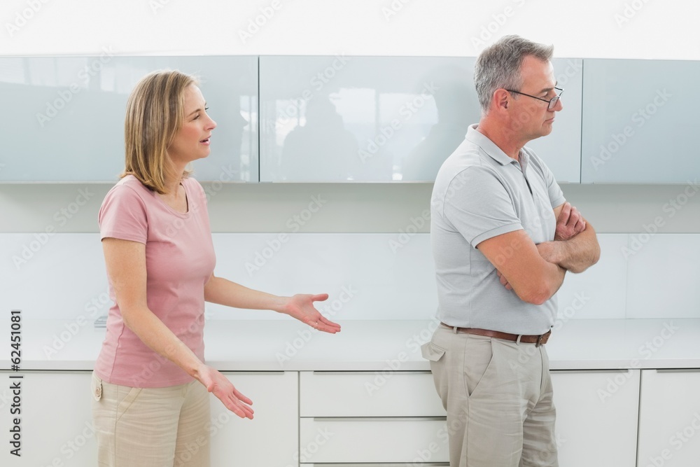 Fototapeta premium Unhappy couple having an argument in kitchen