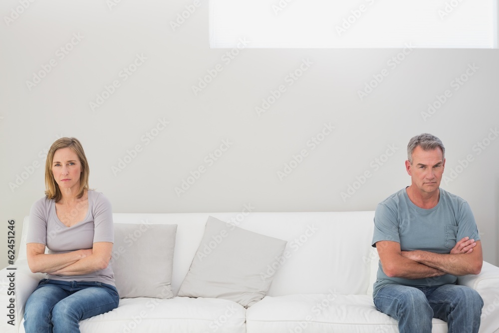 Unhappy couple not talking after an argument at home Unhappy couple not talking after an argument at home