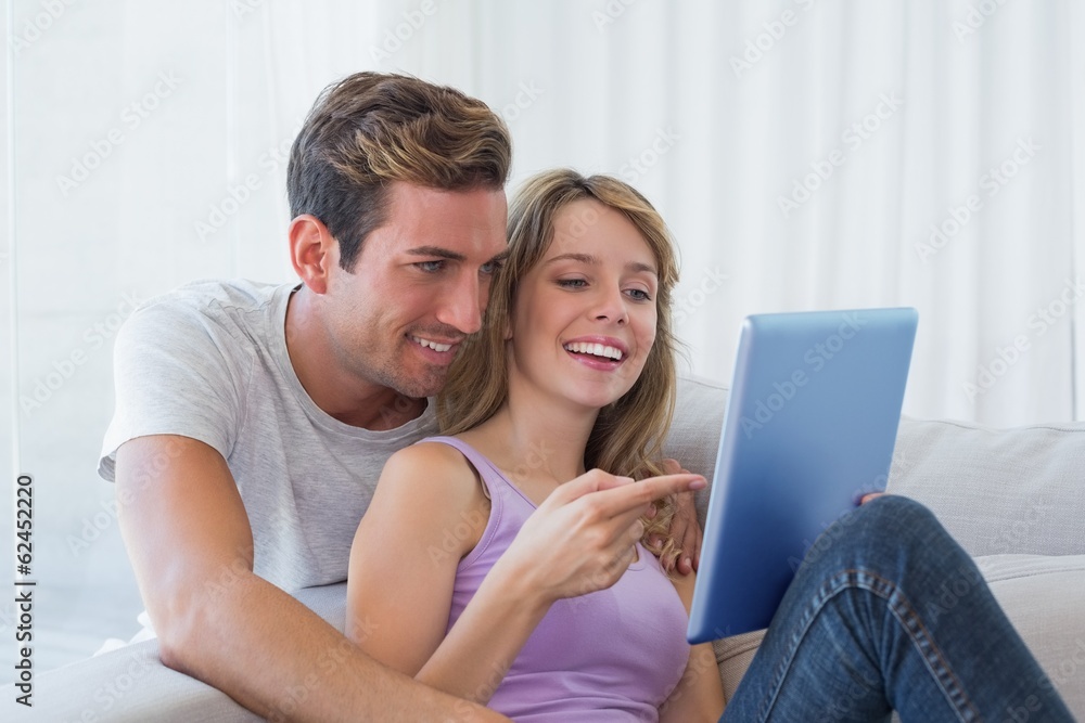 Young couple using digital tablet together Young couple using digital tablet together