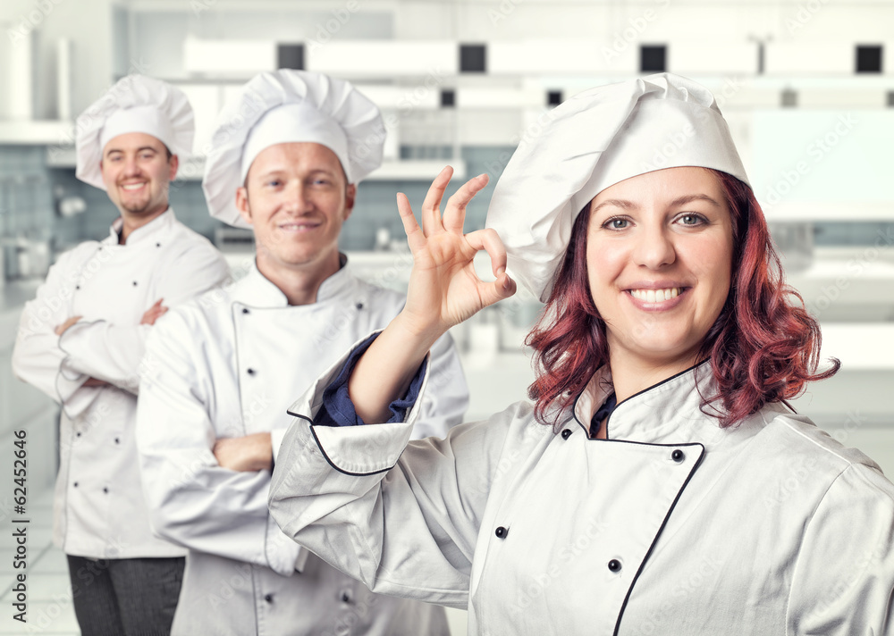 team chef man woman modern kitchen. smiling positive uniform