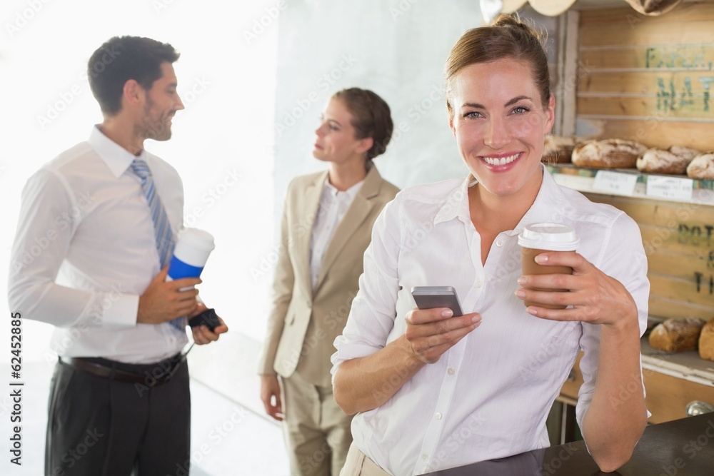Businesswoman using mobile phone in office cafeteria Businesswoman using mobile phone in office cafeteria