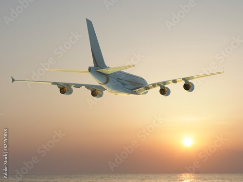 corporate jet airplane flying at sunset