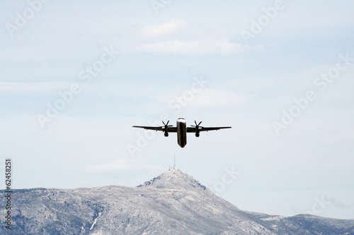 Fototapeta Naklejka Na Ścianę i Meble -  small plane taking off or landing with mountain background