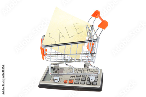 Paper sheet in shopping cart on calculator isolated on white