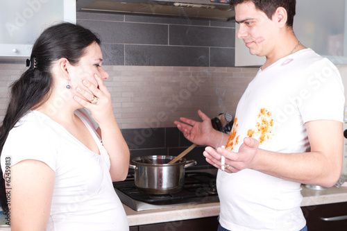 Handsome young man cooking and smoking photo