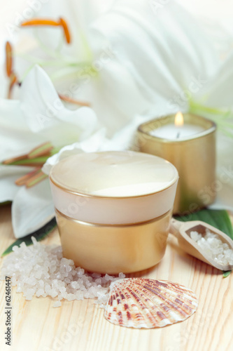 Moisturizing face cream with candle and white lilies