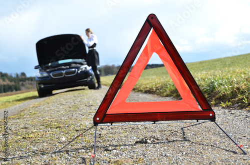 Broken car, girl and warning triangle photo