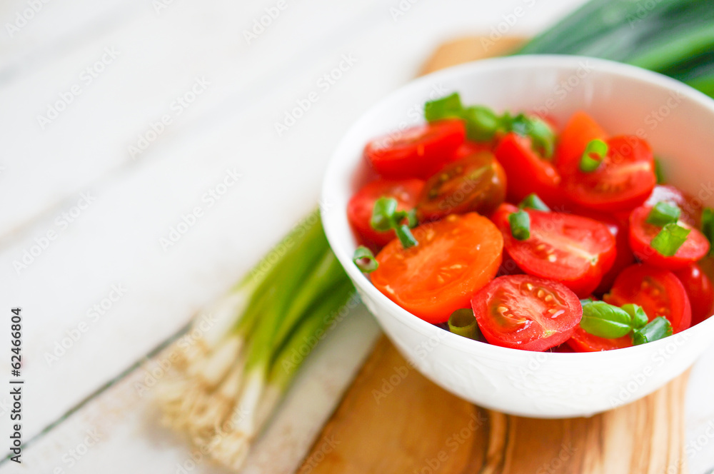 Colorful tomatoes on board on wooden background