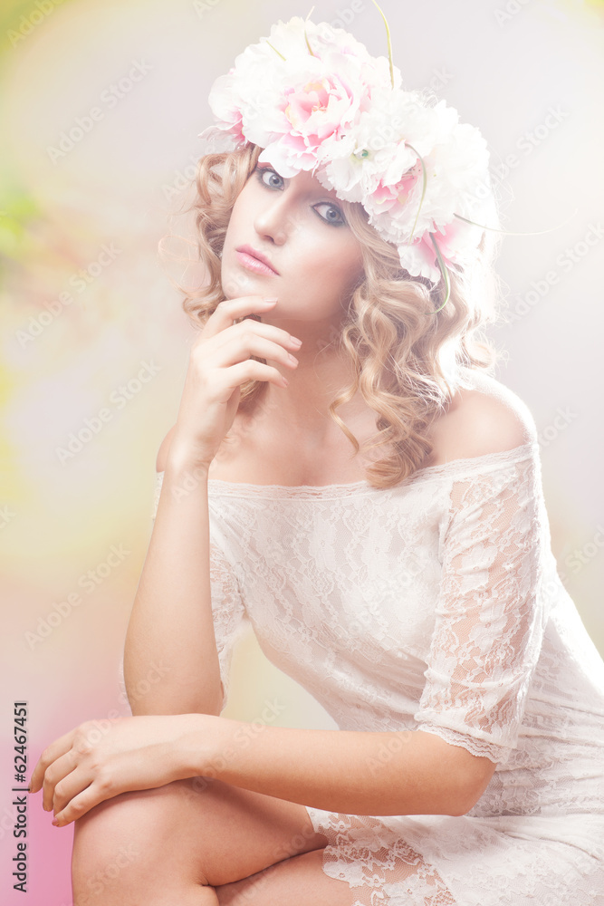 Portrait of a beautiful blonde woman with flowers in her hair. Portrait of a beautiful blonde woman with flowers in her hair.