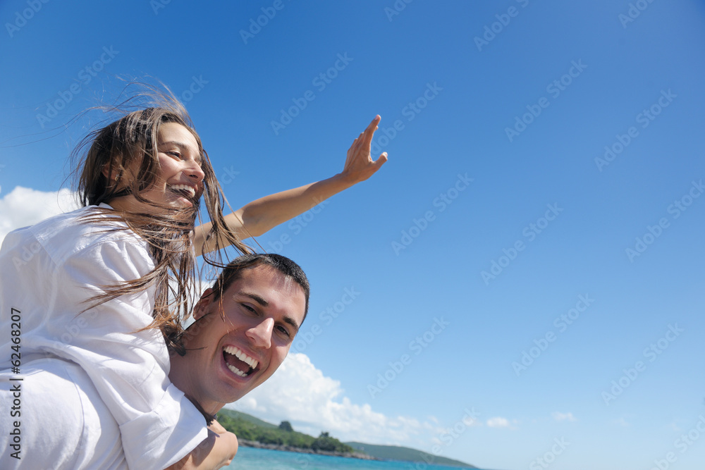 happy couple have fun on the beach happy couple have fun on the beach