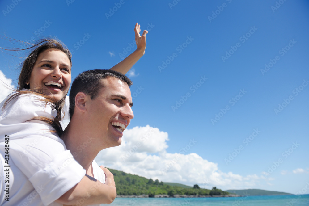 happy couple have fun on the beach happy couple have fun on the beach