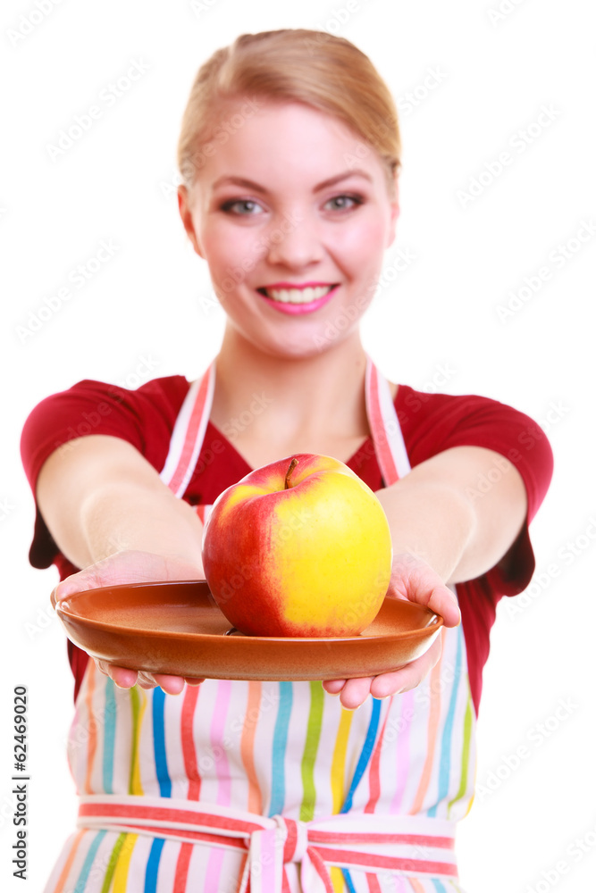 Happy housewife or chef in kitchen apron showing apple isolated Happy housewife or chef in kitchen apron showing apple isolated