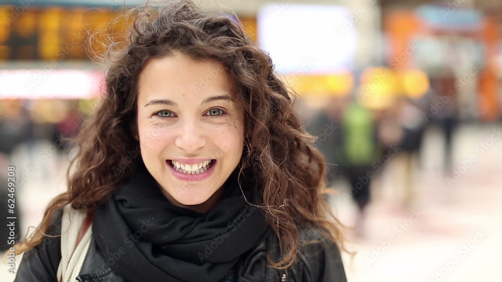 Portrait of a young happy woman smiling at a station Portrait of a young happy woman smiling at a station