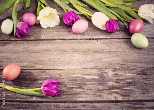 tulips and easter eggs on wooden background