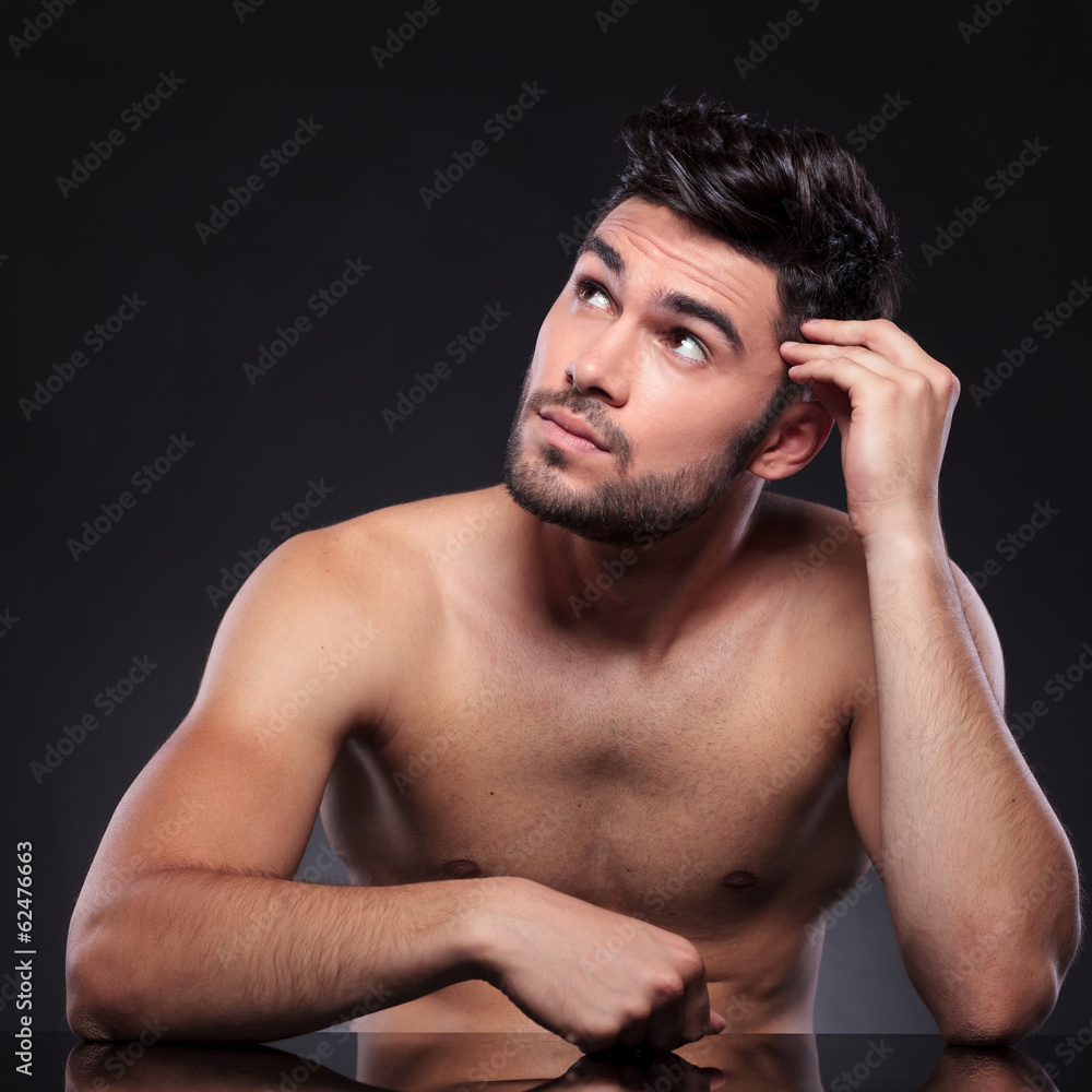 naked young man looks up naked young man looks up