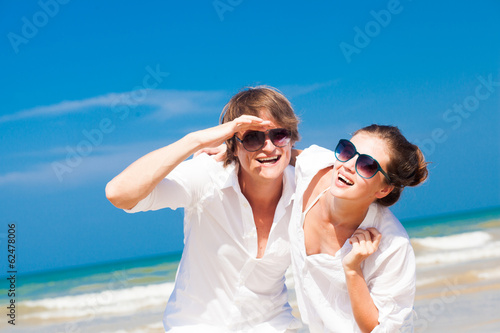 Closeup of happy young couple in white clothes having fun