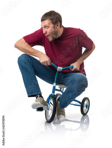 Curious man on a children's bicycle on white background