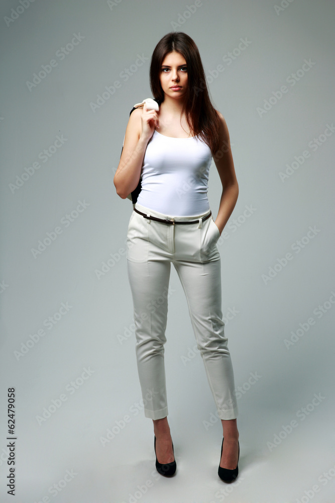 woman in casual clothes standing on gray background woman in casual clothes standing on gray background