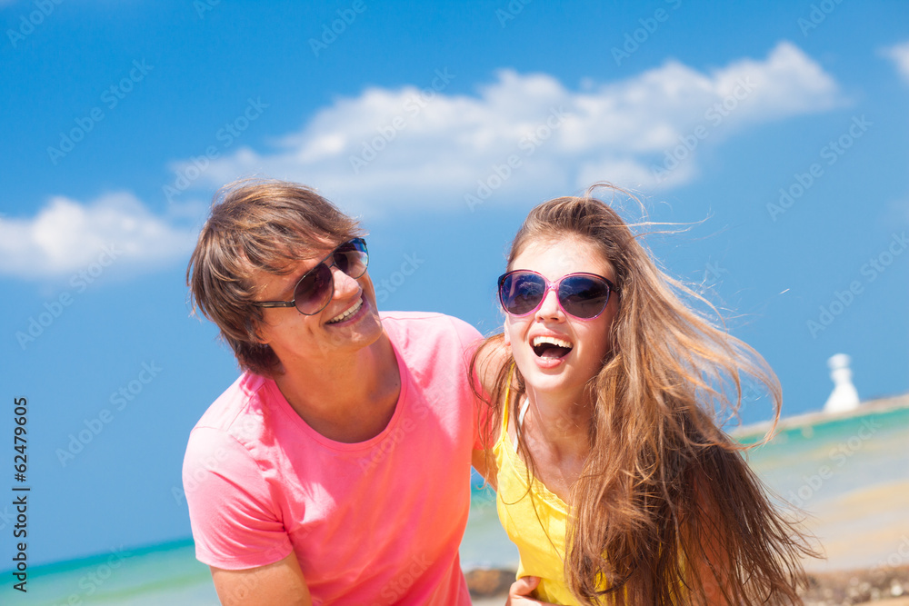 Closeup of happy young caucasian couple in sunglasses smiling on Closeup of happy young caucasian couple in sunglasses smiling on