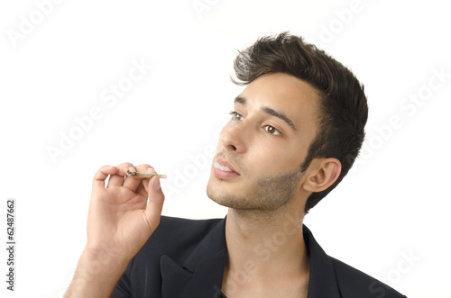 Young beautiful businessman smoking a cigar, tabacco addiction © iulianvalentin