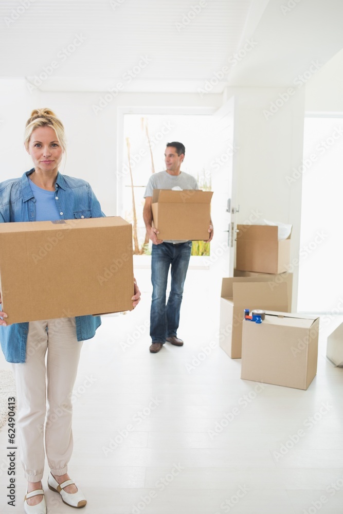 Smiling couple moving together in a new house Smiling couple moving together in a new house