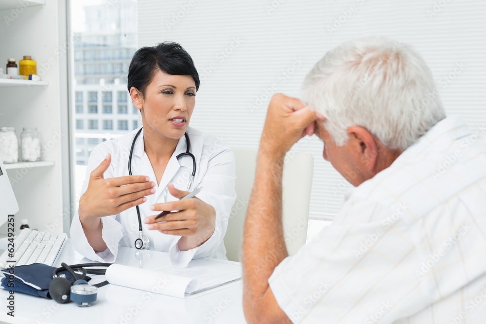 Female doctor explaining reports to senior patient Female doctor explaining reports to senior patient