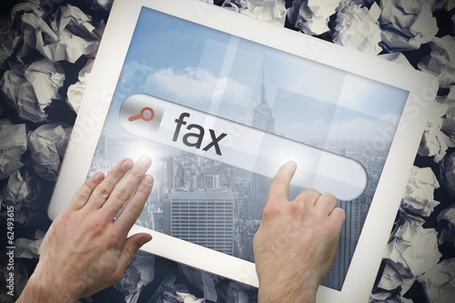 Hand touching fax on search bar on tablet screen photo
