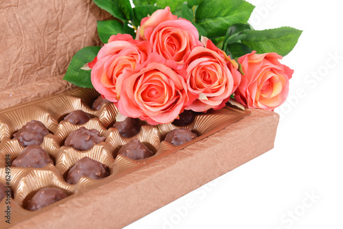 Delicious chocolates in box with flowers close-up © Africa Studio